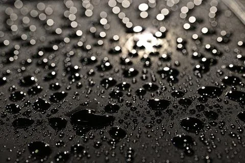 Close-Up of Water Droplets on Dark Surface Stock Photos