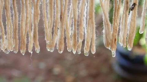 Close up of water droplets falling from a wet cloth being dried Stock Footage 306778593