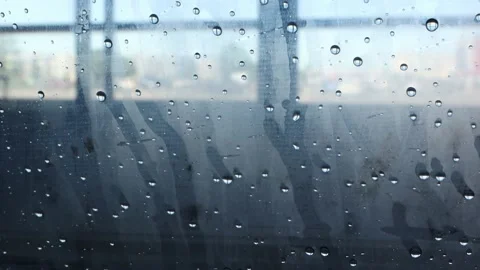 Close-up of water droplets running down the glass, leaving a trail behind them. Stock Footage 156056784