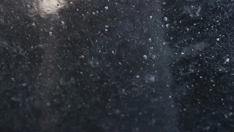 Close-up of water droplets running down the glass, leaving a trail behind them. Stock Footage 156057106