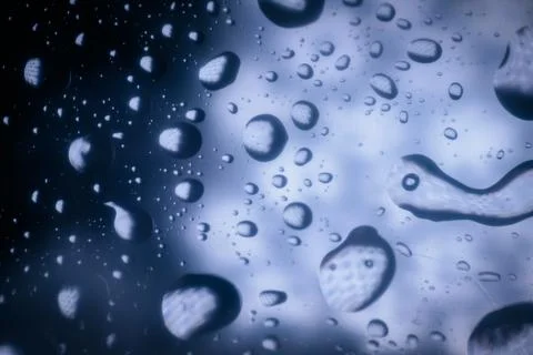 Close-up of water droplets on a smooth surface, reflecting light and creati.. Stock Photos