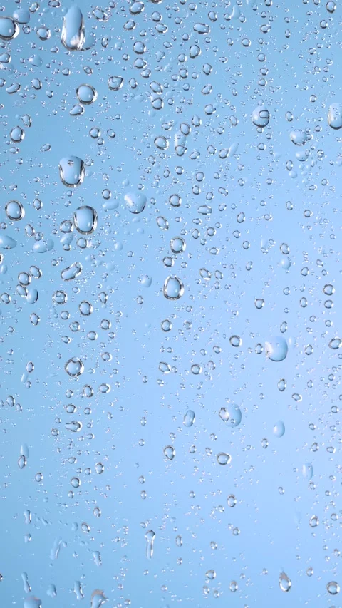 Close-up of water droplets on window, rainfall. Water drops falling on wind.. Stock Footage 307305003