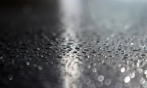 Close up of water drops on the dark stone table surface Stock Photos