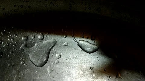 Close-up of water drops flowing down a metal surface. Stock Footage 204936923