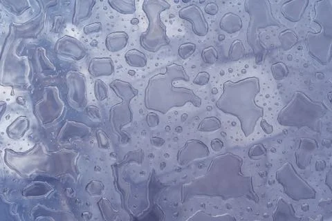 Close-up water drops pattern on glass surface abstract background. Toned purple Stock Photos