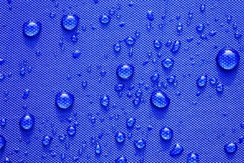 Close up Water drops pattern over a blue waterproof cloth background. World W 写真素材