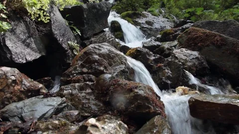Close up of water falling between rocks at mountain stream Stock Footage 70573799