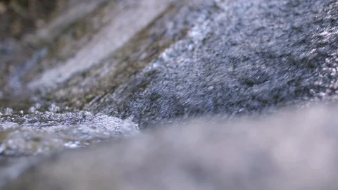 Close up on water falling down along a rocky face Video stock 91709817