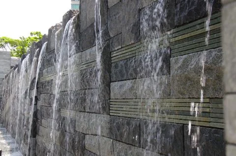 Close up water falling down  a stone water feature Stock Photos