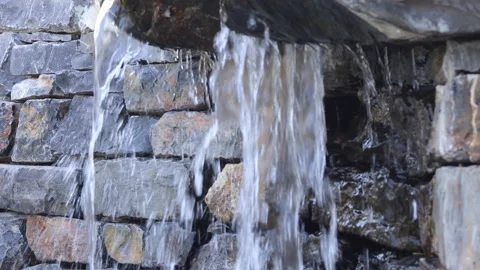 Close up of water falling - garden decoration - 4K loop footage Stock Footage 154354505
