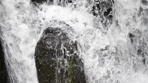 Close up of water falling over rocks Stock Footage 108055893