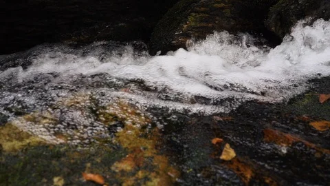Close Up Water Flowing down Waterfall into Natural Pool on Mountain Side Stock Footage 96720554