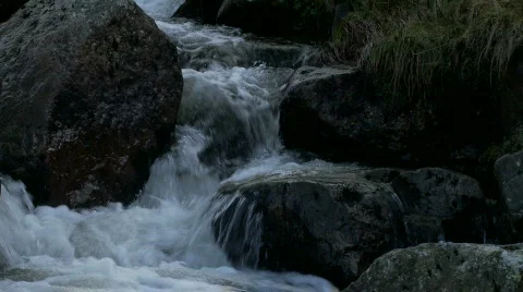 Close up of water flowing over rocks and boulders Video stock 508013