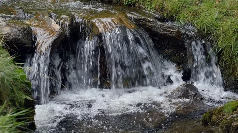 Close up of water flowing over rocks and into pool Stock Footage 93808331