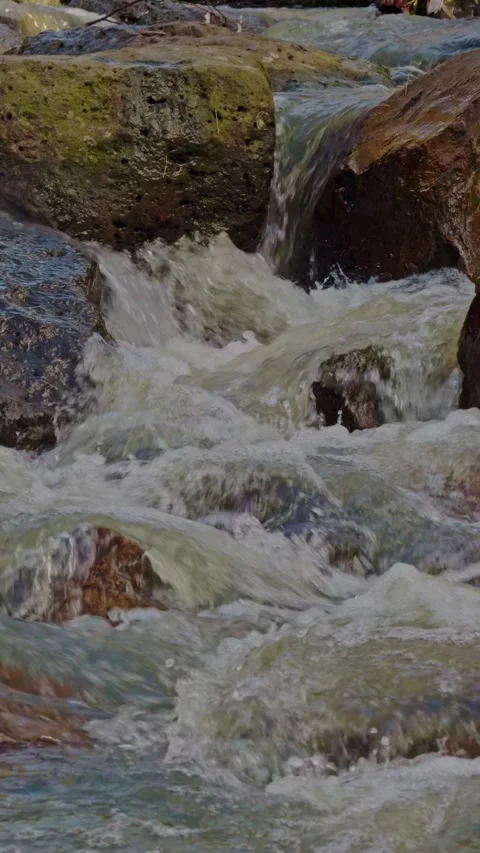 Close-up of water flowing over rocks in urban waterway Stock Footage 321999372