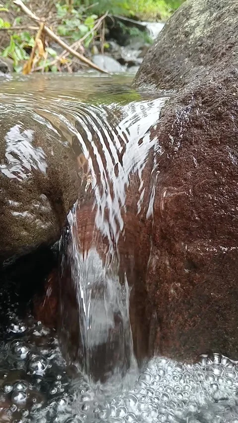 Close Up of Water Flowing Over Rocks in Natural Stream Stock Footage 329899370