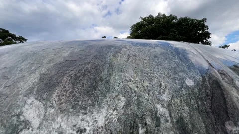 Close-Up of Water Flowing Over a Weathered Stone Surface Stock Footage 340517859