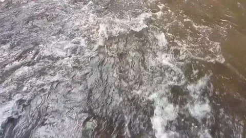 Close up of water flowing in the river during the day Stock Footage 243947598