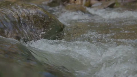 Close up of water flowing in a river Slow  mo Stock Footage 207939356