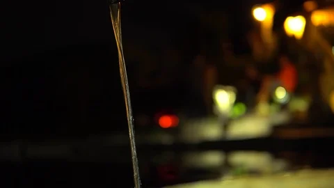 Close-up, water flows from the hose, on a dark blurred background. The Stock Footage 92802935