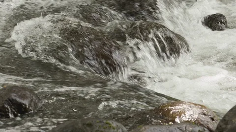 Close up of water foaming up on small waterfall, Tortuguero, Costa Rica Stock Footage 141248857