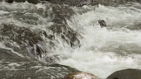 Close up of water foaming up on small waterfall, Tortuguero, Costa Rica Stock Footage 141248958