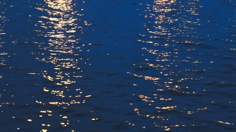 Close up of water pond surface during the night with reflection from city light Stock-Footage 107432542