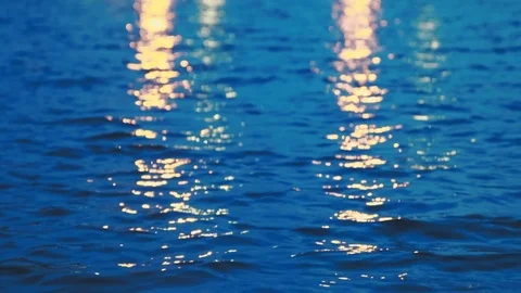 Close up of water pond surface during the night with reflection from city light Видео 107432560