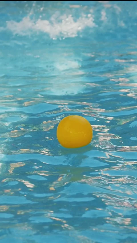 Close-up. In the water pool float two small colored balls. on top of them Stock Footage 311318205