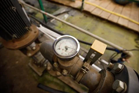 Close up of water pressure sensor or manometer with pipes and valves. Industrial Stock Photos