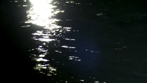 Close up of water ripple in a pond during rainy season at night with reflection Stock Footage 108618412