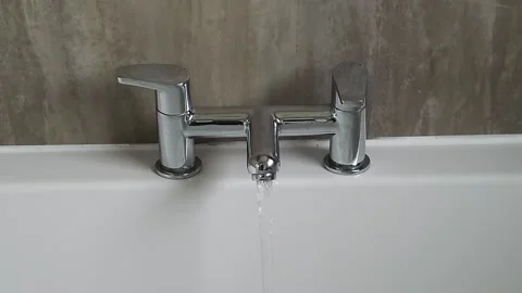 Close up - water running from bath mixer tap Stock Footage 244925374