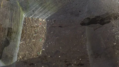 Close up of water splashes into a dirty small pond Stock Footage 117173607