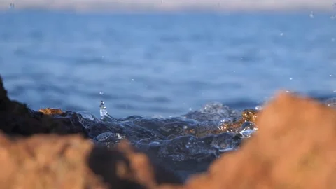 Close up of water splashing between rocky coastal shores outdoors Stock Footage 337409266