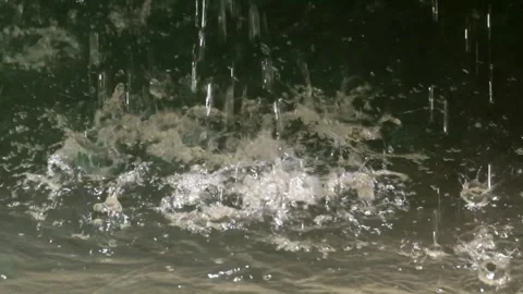 Close up of water splashing from a spring falling into the river. Ecological Stock Footage 321325656