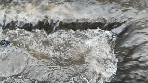 Close Up water stream into sewer after heavy rain Stock Footage 130512984