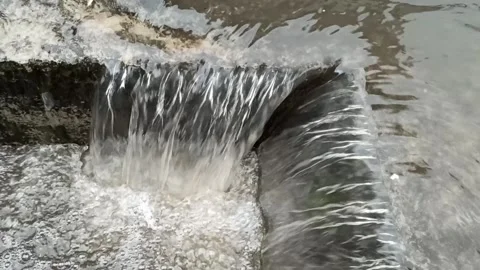 Close Up water stream into sewer after heavy rain Stock Footage 130513067