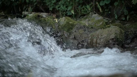 Close up of water stream with white and transparent bubbles. Slow motion Stock Footage 112259636