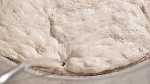 A close-up of a water supply to a container with dough starter in a dough Stock Footage 295875125