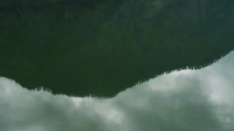 Close up of water surface reflecting green hills on Skull Island, Bali Stock Footage 140267953
