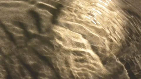 Close-up water surface ripples and splash, palm tree leaf shadow on sand texture Video stock 251282211