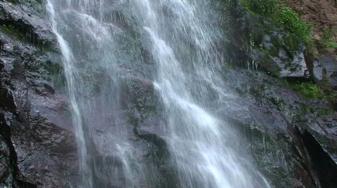 Close-up of Waterfall Along Mountain Rocks Stock Footage 302545