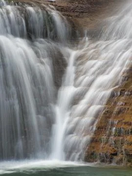 Close-up of Waterfall Cascading Down Rocks - Vertical shot using long expos.. Stock Photos