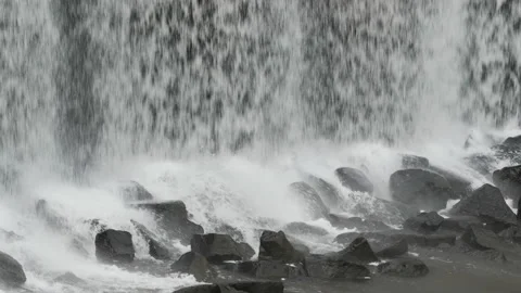 Close up of a waterfall from a dam on to the the rocks below 2. 4K locked tripod Stock Footage 147990143