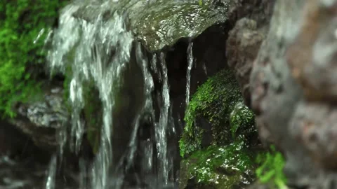 Close up waterfall flow through rough rock with moss Stock Footage 198800126