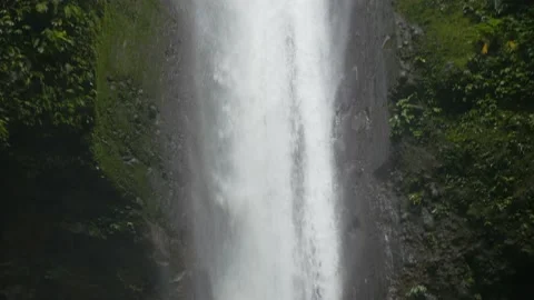 Close-up of a waterfall flowing in a tropical forest, in the Philippines Stock Footage 235471618