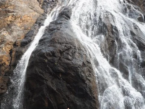 Close-up of the waterfall movement in the Park. The stream of water flows aro Stock Photos