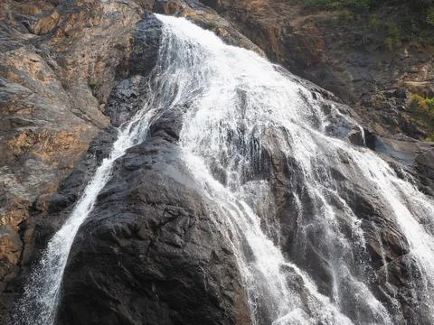 Close-up of the waterfall movement in the Park. The stream of water flows aro Stock Photos