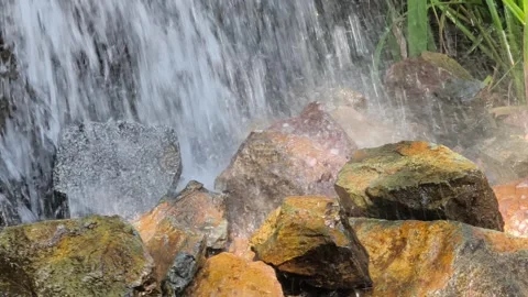 Close up of waterfall rushing over wet stones Видео 345077186