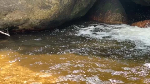 Close Up of Waterfall Rushing Through Rocks Stock Footage 336781864